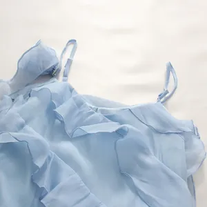 Close-up of light blue chiffon dress with adjustable straps and ruffled neckline