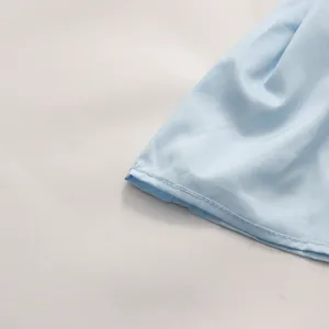 Close-up detail of light blue ruffled hem on this sexy resort-style long dress for women