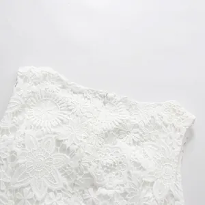Close-up detail of elegant white floral lace embroidery on high-end sleeveless dress
