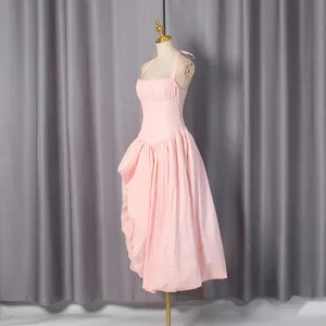 Side view of elegant French style pink sleeveless dress with pleated bodice and full skirt
