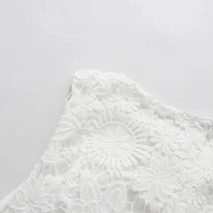 Close-up detail of high-quality white floral lace embroidery on elegant sleeveless dress