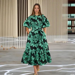 Detail view showing the green floral print and puff sleeves of this elegant long dress
