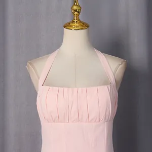 Detailed view of pink halter dress with pleated chest design for a feminine look