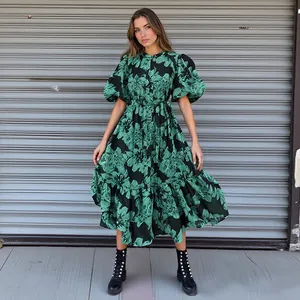 Detail shot of a green floral maxi dress with stylish puff sleeves and waist tie.