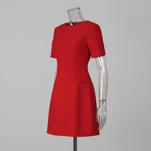 Detail view of red short-sleeved mini dress with elegant round neck design