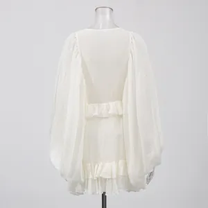 Detailed back view of a white royal style dress with elegant lantern sleeves and ruffles