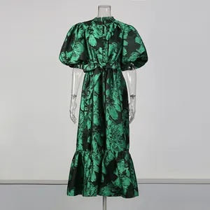 Front view of green floral maxi dress with puff sleeves and belted waist on mannequin