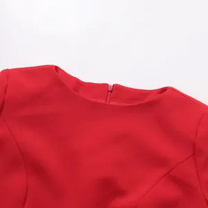 Close-up detail of the elegant round neckline and zipper on this vibrant red dress.