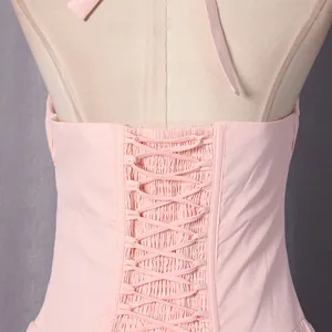 Detailed macro view of the adjustable lace-up corset back on a pink French style midi dress