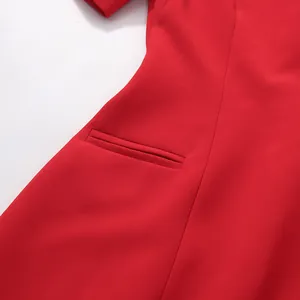 Close-up detail of a welt pocket on a vibrant red fashion waist-slimming dress