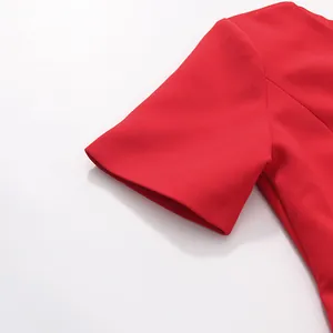 Close-up view showing the short sleeve detail and red textured fabric of a chic dress