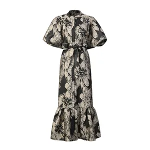 Detailed view of an elegant floral print maxi dress with puff sleeves and waist tie