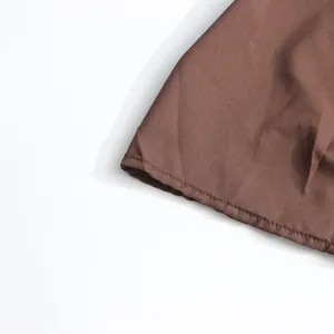 Close-up of fine stitching and brown fabric texture on a vintage palace style dress.