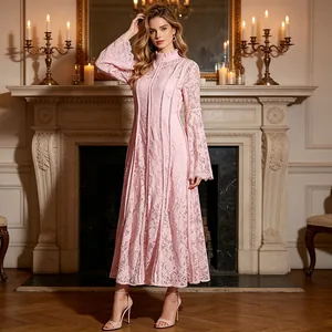Detail of a pink lace maxi dress featuring an elegant mock neck and long bell sleeves.