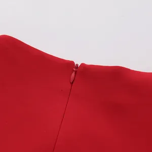High-quality detail shot of the invisible red back zipper on a stylish red dress