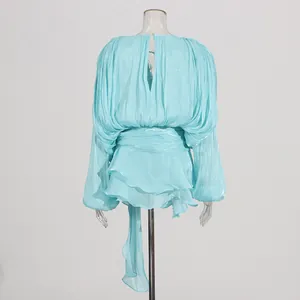 Detailed back view of a light blue pleated puff sleeve dress with a layered ruffle hem