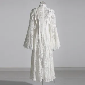 Detailed back view of white floral lace long dress featuring bell sleeves and a high neck