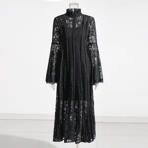 Elegant black lace maxi dress with high ruffled collar and flare bell sleeves detail.