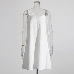 Detail view of a minimalist white slip dress on a clear mannequin