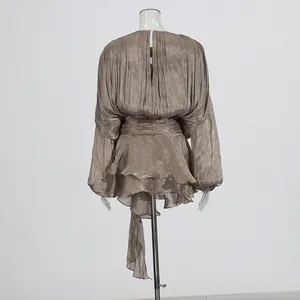 Elegant back view of taupe pleated mini dress featuring tiered ruffles and puffy sleeves