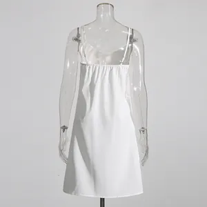Detailed back view of a white minimalist slip dress displayed on a transparent mannequin.