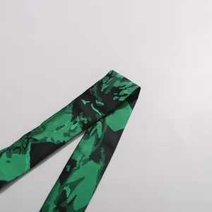 Detailed view of the green and black floral printed fabric strap for a stylish dress