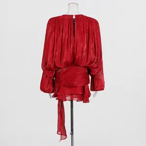 Detailed back view of a red puff-sleeve dress with elegant pleats and layered ruffles.