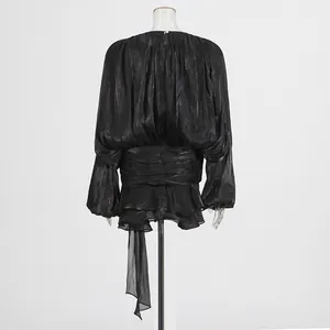 Detailed back view of a black pleated puff sleeve dress featuring elegant ruffle layers