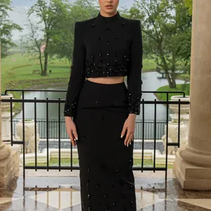 Elegant black two-piece set with intricate beadwork and rhinestones on top and skirt.