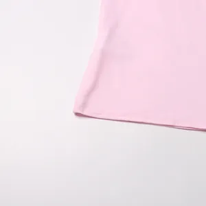 Detail shot of the neat hemline on a pink spring long dress with delicate stitching