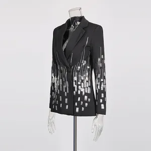 Detail of black blazer with shimmering silver sequin geometric patterns on mannequin