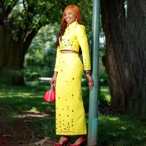 Elegant yellow two-piece set featuring rhinestone embellished crop top and high waist skirt.