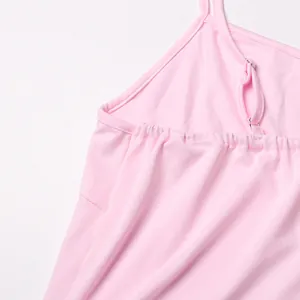Detail shot of a pink dress showing adjustable shoulder strap and soft fabric texture