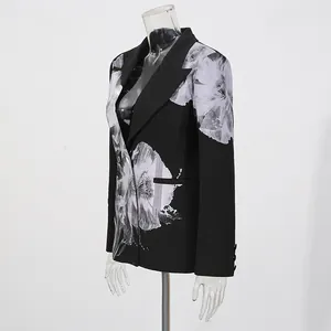 Detailed side view of a black floral print blazer featuring large white flower motifs
