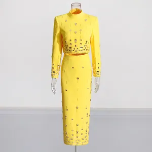 Detail of bright yellow two-piece set with heavy rhinestone and bead embellishments