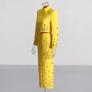 Yellow beaded rhinestone two-piece set with a cropped top and high waist skirt.