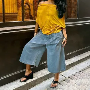 Full view of light blue wide-leg denim culottes paired with a yellow off-shoulder top.