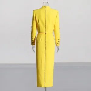 Detailed back view of a vibrant yellow two-piece suit with gold zippers and embellished cuffs