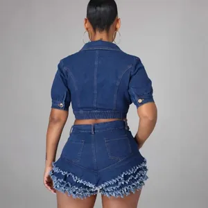 Rear view of stylish denim two-piece set with frayed ruffle shorts and crop jacket
