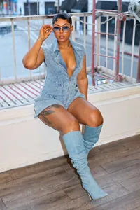 Sexy high-stretch denim zip-up romper jumpsuit worn by a model in a stylish setting