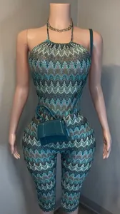 Full detail of a stylish printed halter neck backless jumpsuit displayed on a mannequin