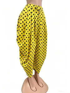 Close-up of yellow wide-leg bubble pants with black polka dots on a mannequin