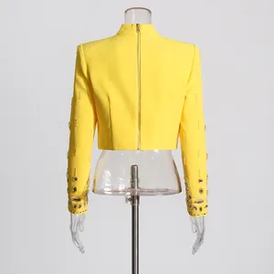 Bright yellow cropped blazer with elaborate rhinestone and bead details on sleeves