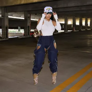Model wearing dark wash irregular cutout denim pants with zipper detail in street style