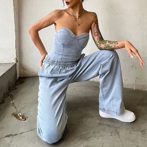 Close-up of a stylish light blue denim corset top and wide-leg trousers set