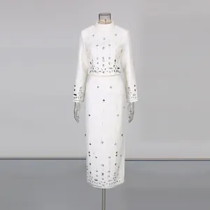 Elegant white two-piece set with beaded rhinestone top and high waist pencil skirt