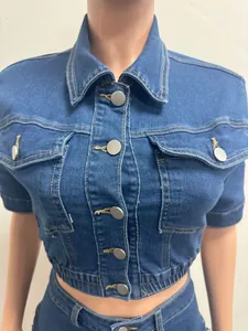 Close-up detail of a fashionable slim-fit denim button-down crop top featuring chest pockets