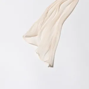 Close-up view showing the delicate pleated fabric and textured detail of a cream ruffle dress