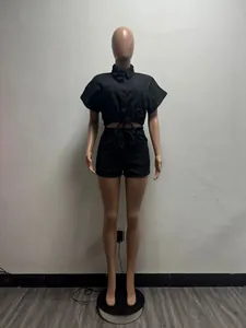 Women's two-piece black denim set with cropped button-down shirt and shorts on mannequin