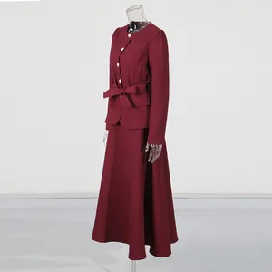 Side view of burgundy vintage round neck blouse and high waist skirt set on mannequin